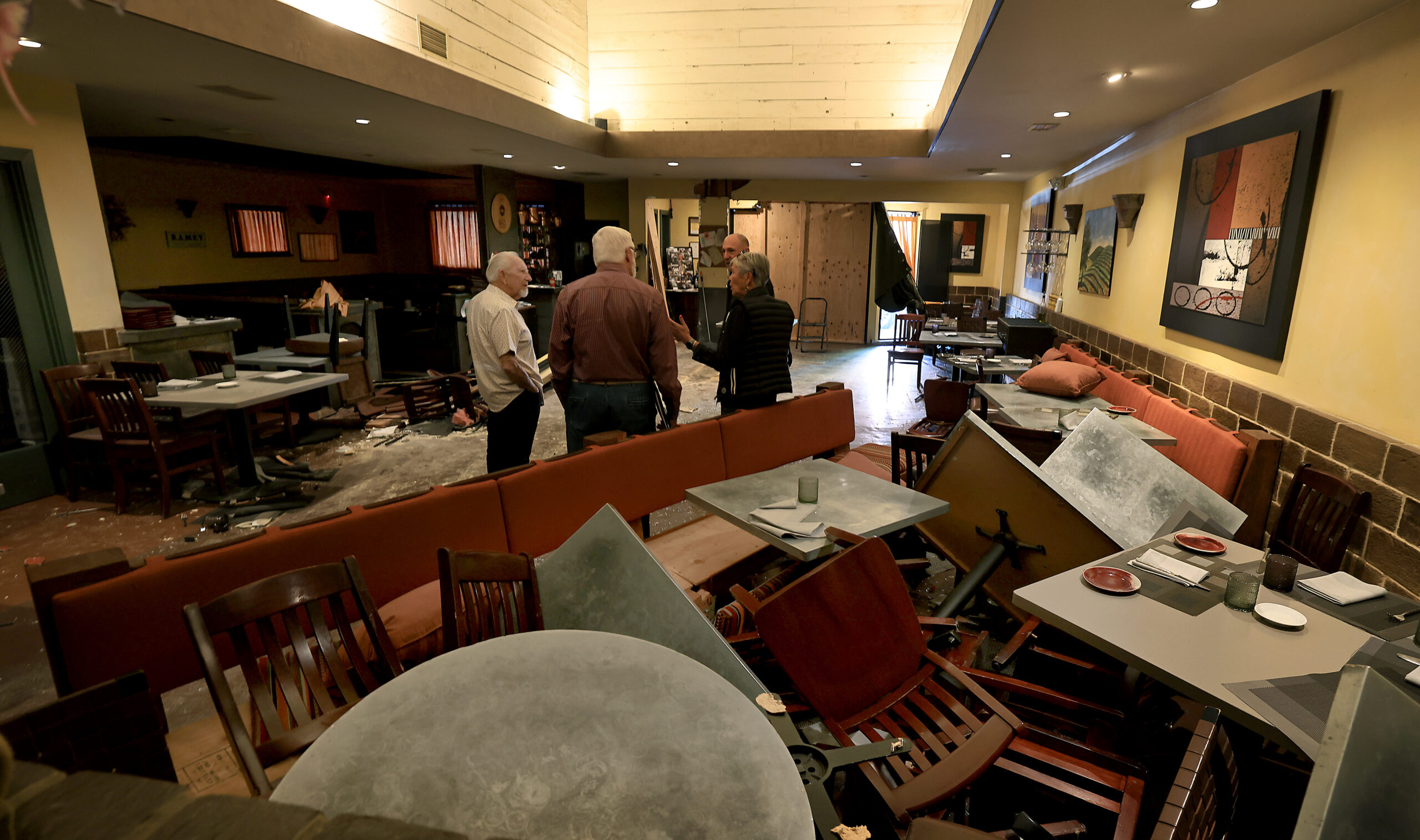 Debris remains after a vehicle plowed through Baci Cafe and Wine Bar